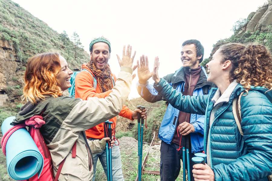 group of travelers high fiving